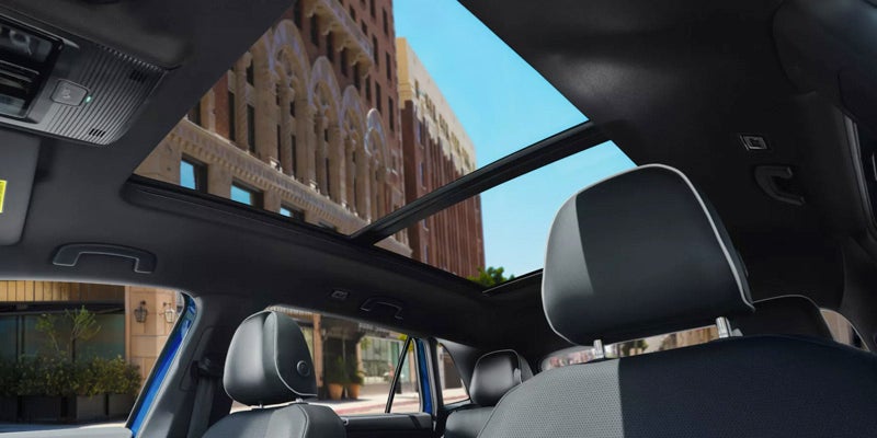 Interior view of 2026 Volkswagen Atlas Cross Sport with panoramic sunroof open.