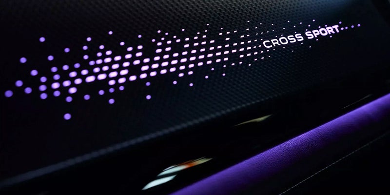 Illuminated Atlas Cross Sport interior trim with ambient lighting detail.